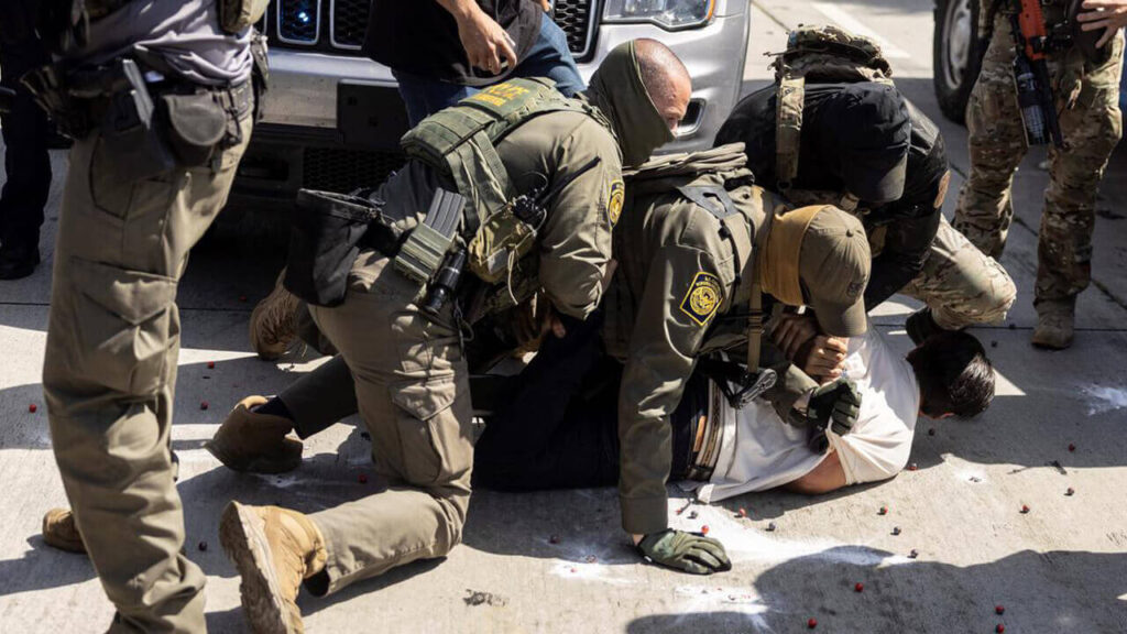 Los miembros del ICE sobre el cuerpo de un inmigrante que será capturado para regresarlo a su país