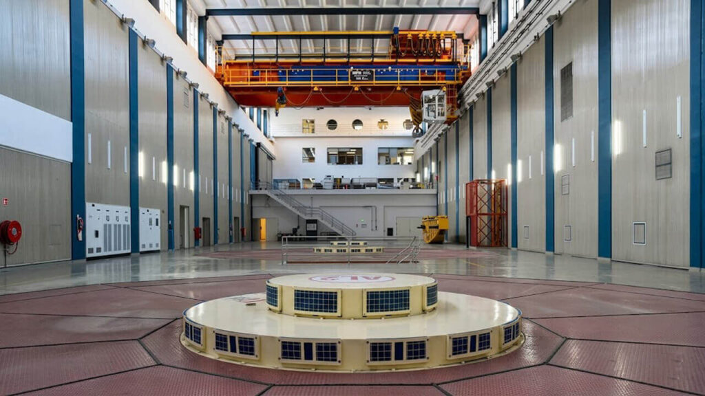 Interior de la casa de máquinas de Alicurá: vista de uno de los generadores hidroeléctricos y el puente grúa utilizado para tareas de mantenimiento dentro de la central.