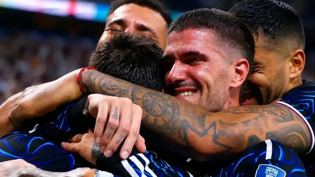 Rodrigo De Paul y Lionel Messi se funden en un emotivo abrazo tras el pitazo final. A su alrededor, sus compañeros celebran entre sonrisas y lágrimas la clasificación de la Selección Argentina a la final del Mundial 2026, luego del triunfo 2-1 sobre Inglaterra.