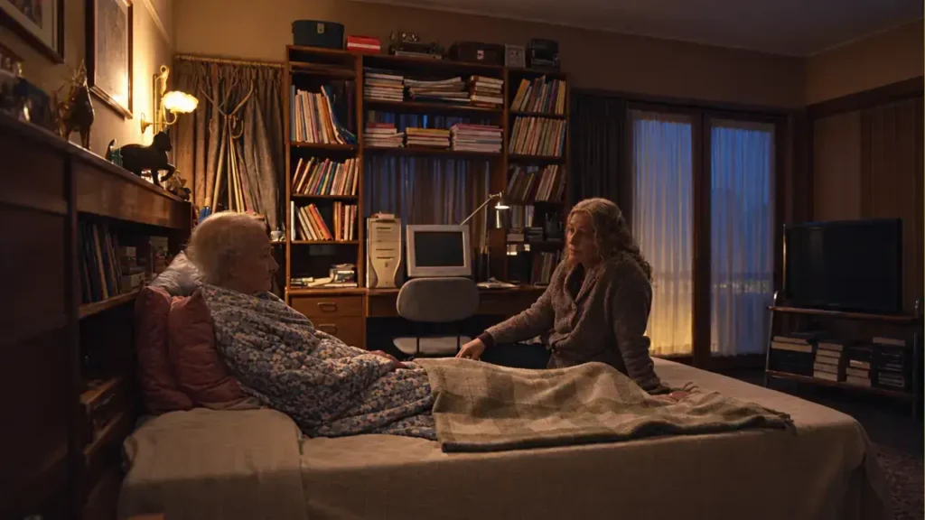 Mercedes Morán conversa junto a la cama con una mujer mayor y moribunda en una habitación signada por una biblioteca que esconde miles de historias.