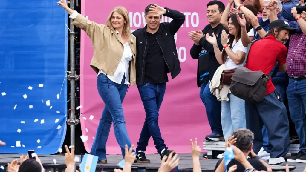 La vicegobernadora Verónica Magario y el gobernador Axel Kicillof saludan a la militancia al ingresar al escenario del encuentro.